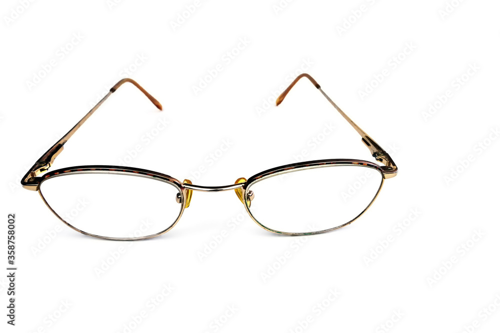 corrective glasses with metal light brown frames on a white background