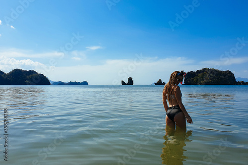 Slim and tanned girl in the sea