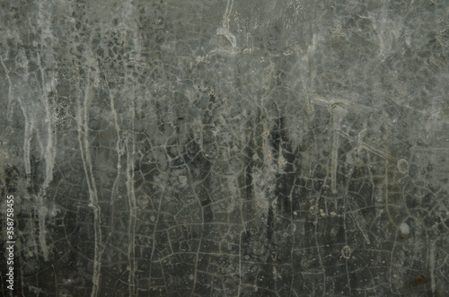 The cracks on the surface of the gray cement wall for background.Free pattern on gray wall.