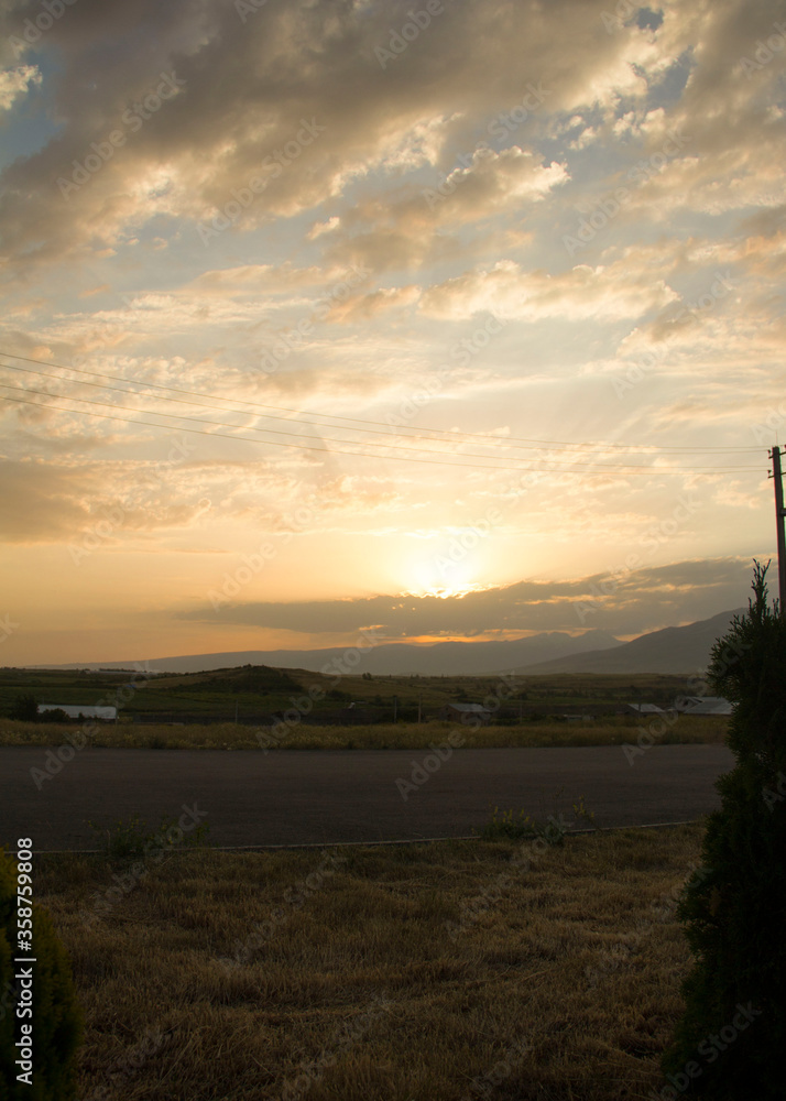 Sunset in the village over meadows and mountains
Sunset in the village over meadows and mountains