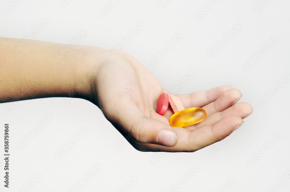 Hand holding different Pills Against White background, Hand holding different Pills Against White background,
