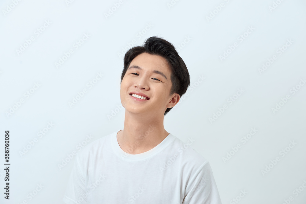 Portrait of a young Asian man making a confident smile Portrait of a young Asian man making a confident smile