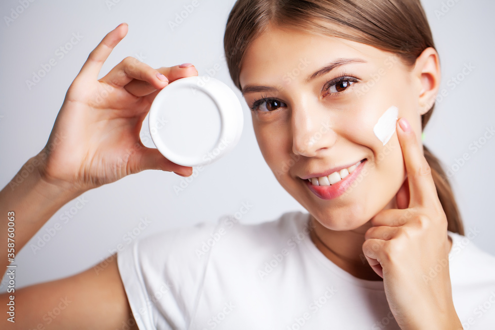 Skin care, young woman with beauty face use facial skin cream Skin care, young woman with beauty face use facial skin cream