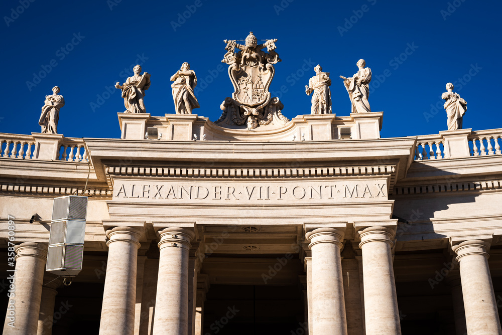 Statues above the columns of the arches around St. Peter's Square at the entrance to the Vatican in Rome