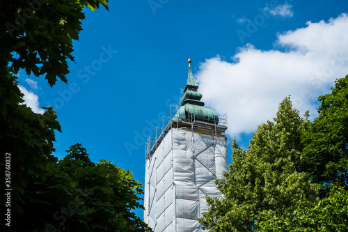 Принти на полотні A church tower covered by scaffolding due to construction work in Bavaria, Germa