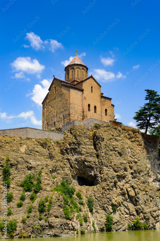 It's Metekhi Church on the elevated cliff that overlooks the Mtkvari river, one of the most popular landmarks of Tbilisi