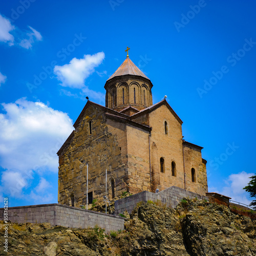 It's Metekhi Church on the elevated cliff that overlooks the Mtkvari river, one of the most popular landmarks of Tbilisi