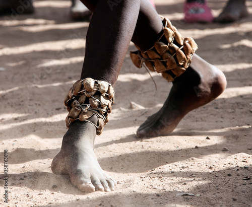 Canvastavla Feet of a black teenager dancing on the sand folk ritual dance.