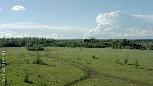 Tula oblast romantsevo hills under bright blue sky drone aerial shot. High quality 4k footage fly over tulskaya oblast romantsevskie hills, konduki shot under cloudy blue sky photo