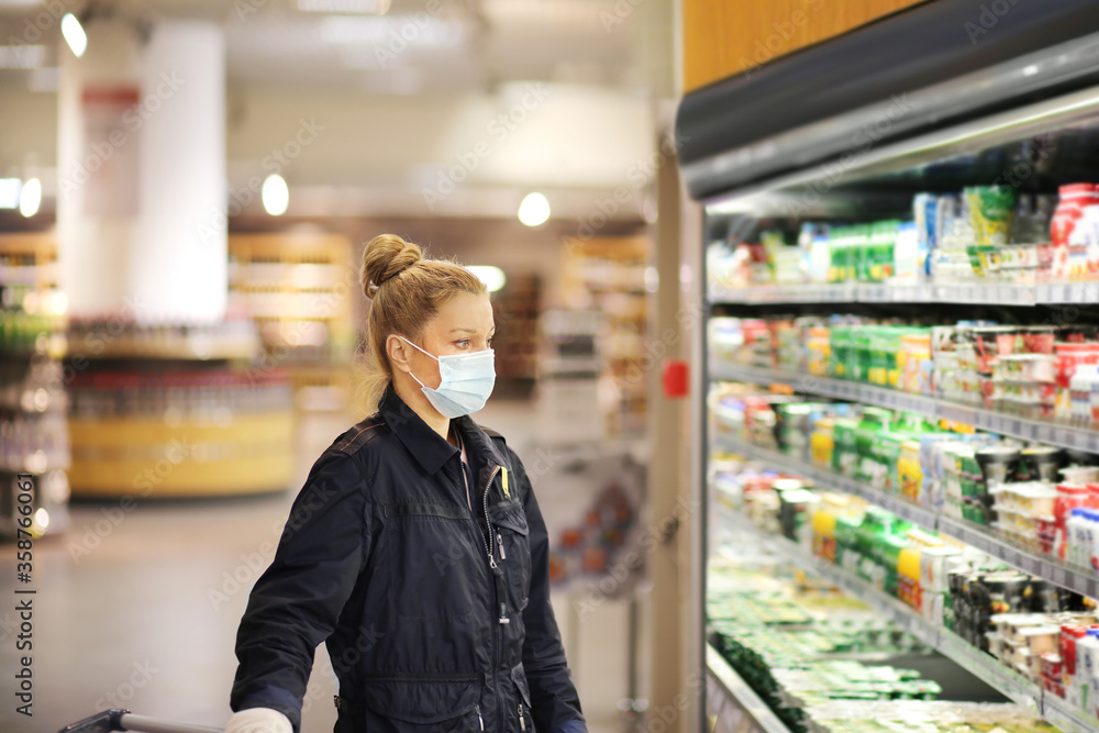 Supermarket shopping, face mask and gloves,Woman choosing a dairy products at supermarket