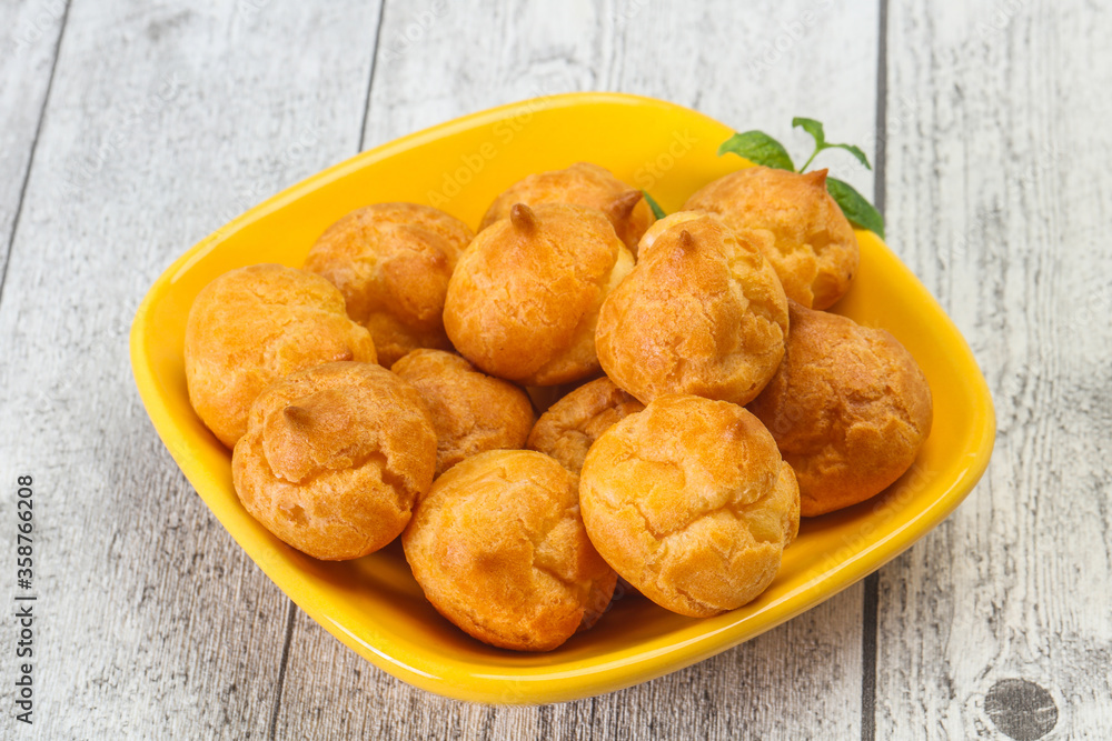 Sweet tasty profiteroles heap in the bowl Sweet tasty profiteroles heap in the bowl