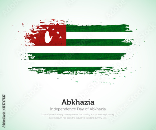 Independence day of Abkhazia country. Abstract flag in shape of paint brush stroke with shiny colored background