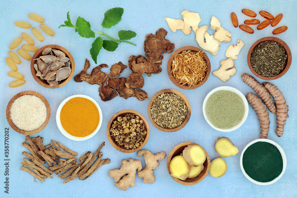 Herbs and spices used in chinese herbal medicine to treat irritable bowel syndrome with dietary supplement powders, evening primrose & fish oil capsules. Flat lay.