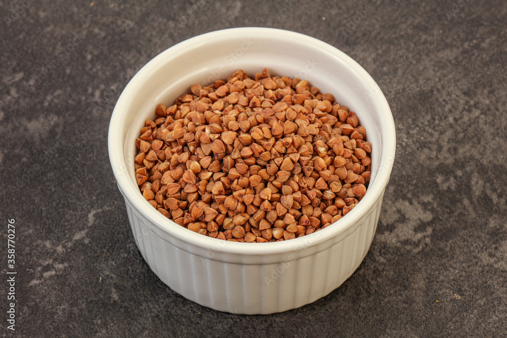 Raw buсkwheat cereal in the bowl Raw buсkwheat cereal in the bowl