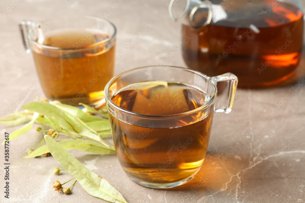 Composition with linden tea on gray background, close up. Natural tea Composition with linden tea on gray background, close up. Natural tea