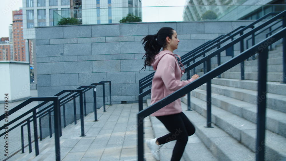 Athlete woman running up stairs on outdoor workout. Fit girl jogging upstairs
