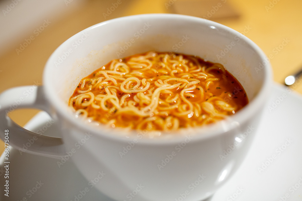 Hot spicy noodle soup closeup with out of focus elements Hot spicy noodle soup closeup with out of focus elements