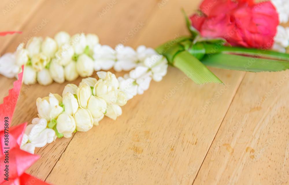 Garland to pay respect of Thai culture on wood plate Garland to pay respect of Thai culture on wood plate