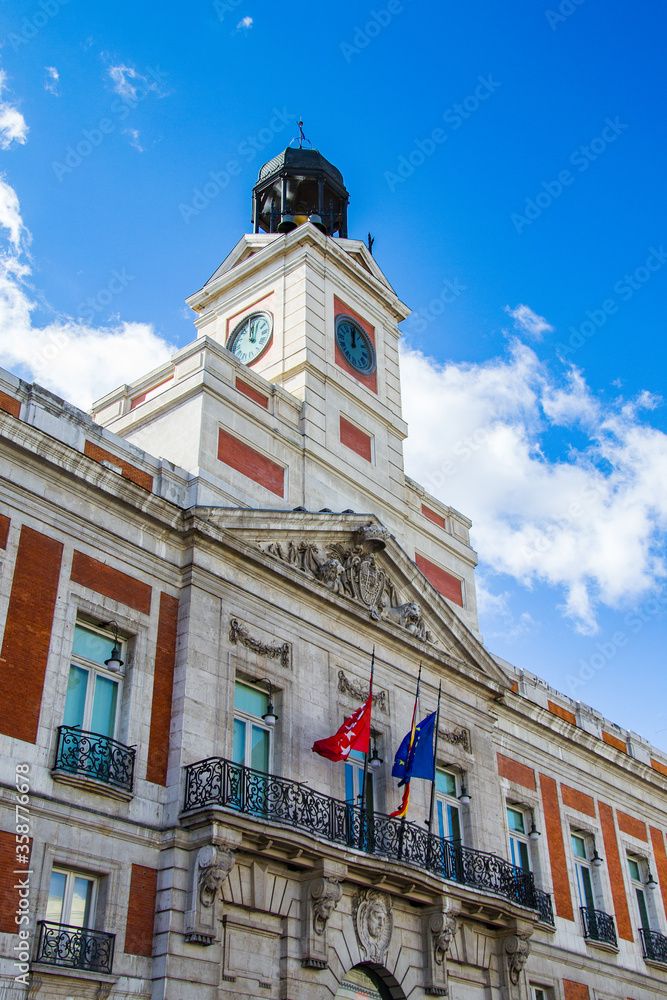 Fototapeta premium It's House of the Post Office on the Puerta del Sol, Madrid, Spain. Puerta del Sol is the centre (Km 0) of the radial network of Spanish roads.