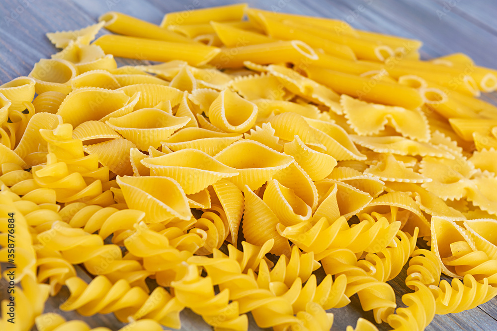 Different dry pasta on a wooden background Different dry pasta on a wooden background