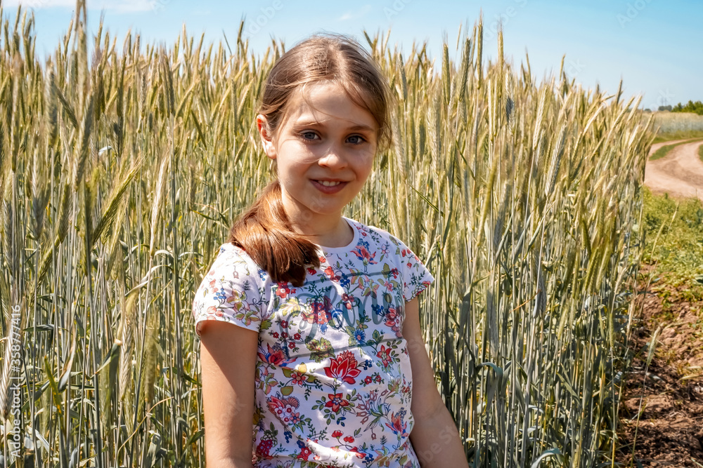 Girl child on the background of a wheat field Girl child on the background of a wheat field