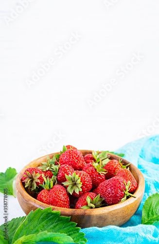 Sweet fresh ripe strawberry isolated on white wooden background.