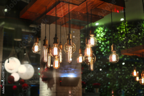 Fotografering closeup on group of different Vintage Edison Light Bulb types illuminated in a d
