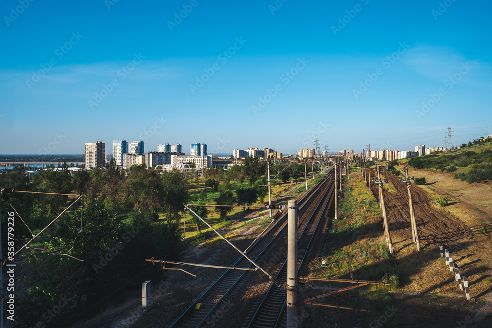 Fototapeta premium Railway with rails on the ground against the background of the city of Volgograd
