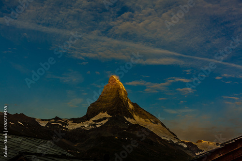 Zermatt, Switzerland. Matterhorn mountain near Grindjisee Lake with flowers in the foreground. Canton of Valais.