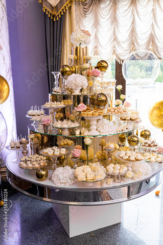 Delicious sweets on candy buffet. Candy bar on wedding ceremony with a lot of different candies.