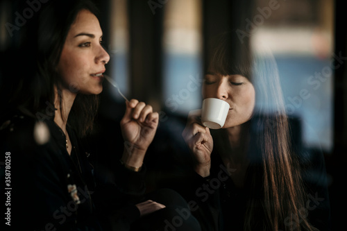 Europe, Germany, Berlin, Woman having fun whilst drinking in a bar.