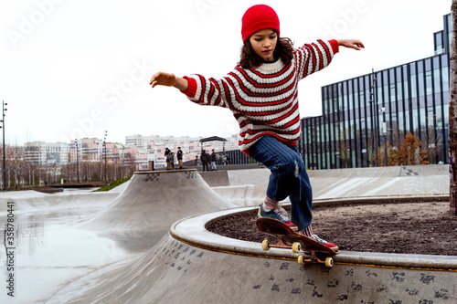 Young Girl on skateboard in Skate Park