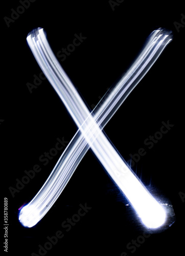 Handwrite letter X, made with light painting technic isolated on black. Light effect font of full alphabet set of upper case letters.