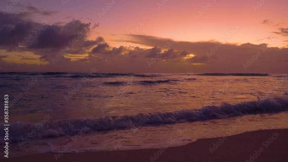 SLOW MOTION: Swell coming from the open seas approaches a paradise island at colorful sunset. Refreshing ocean waves splash while rolling towards a remote tropical island on a sunny summer evening. SLOW MOTION: Swell coming from the open seas approaches a paradise island at colorful sunset. Refreshing ocean waves splash while rolling towards a remote tropical island on a sunny summer evening.