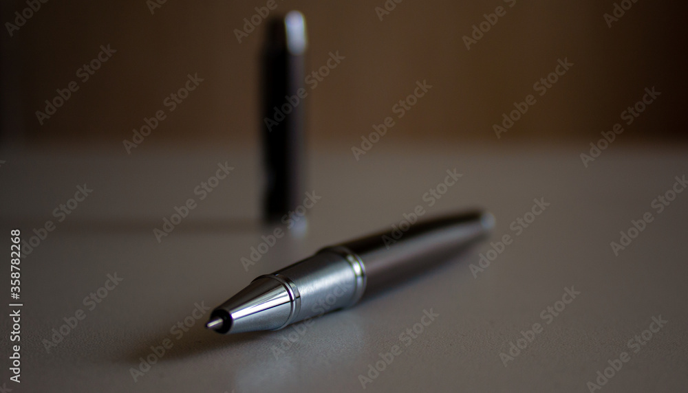 Beautiful dark pen with cap on grey office table. Concept. Beautiful dark pen with cap on grey office table. Concept.