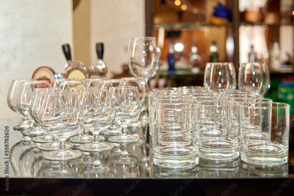 Clean sparkling wineglasses on table in bar, copy space
