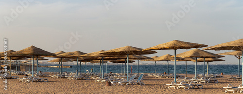 Empty beaches of Egypt. Umbrellas and sun beds in Hurghada without tourists. The end of the red sea holiday.