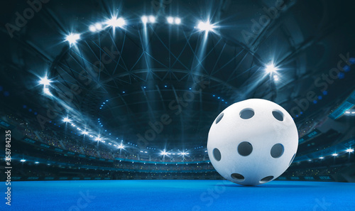 Obraz na plátně Magnificent floorball arena with a floorball ball on a blue artificial floor with spectators on the grandstand