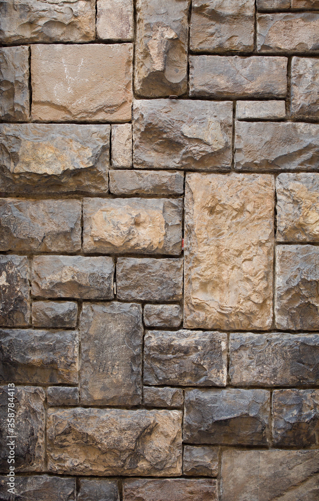 Fototapeta premium Ancient brick stone wall. Antique brickwork with stones of different sizes. Close up shot. Abstract texture or background.