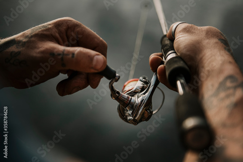 Close up of man holding fishing rod