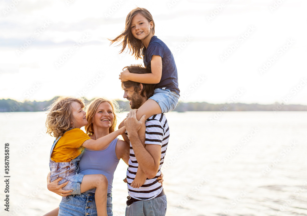 Young family enjoying time at the beach 
