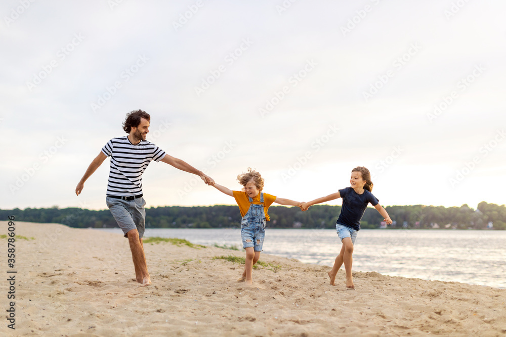 Father with two children enjoying a day at the beach