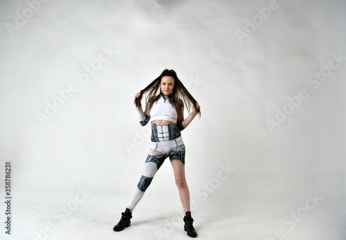 beautiful brunette girl in a robot suit posing on a white background