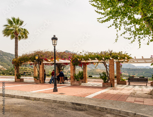 Maro Costa Del Sol Spain Local Villagers meeting under a pergola in Maro village centre