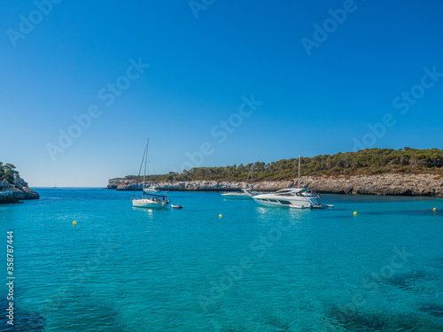 Mondragó Natural Park Mallorca Spain yachts and pleasure craft moored in the bay looking out into the mediterranean sea