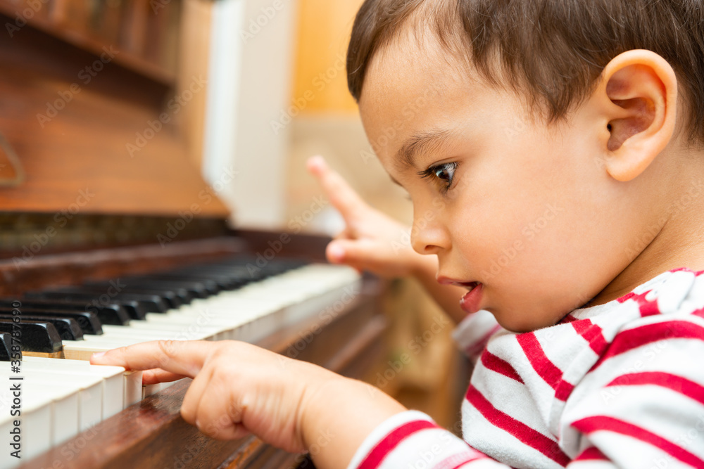 Litlle boy playing the piano, toddler learning music at home Litlle boy playing the piano, toddler learning music at home