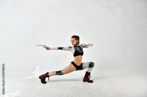 beautiful brunette girl in a robot suit posing with silver pistols
