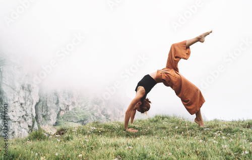 Yoga on nature. Young woman is practicing yoga in mountains
