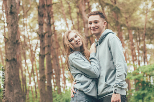 couple in identical sweatshirts in the forest, portrait of a couple in the forest © Катя Данилюк
