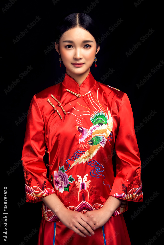 Bride in Asian costume in black background Bride in Asian costume in black background